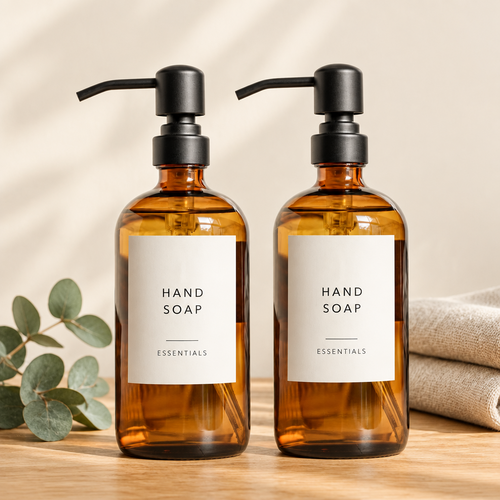 Two amber glass soap dispensers on a wooden counter